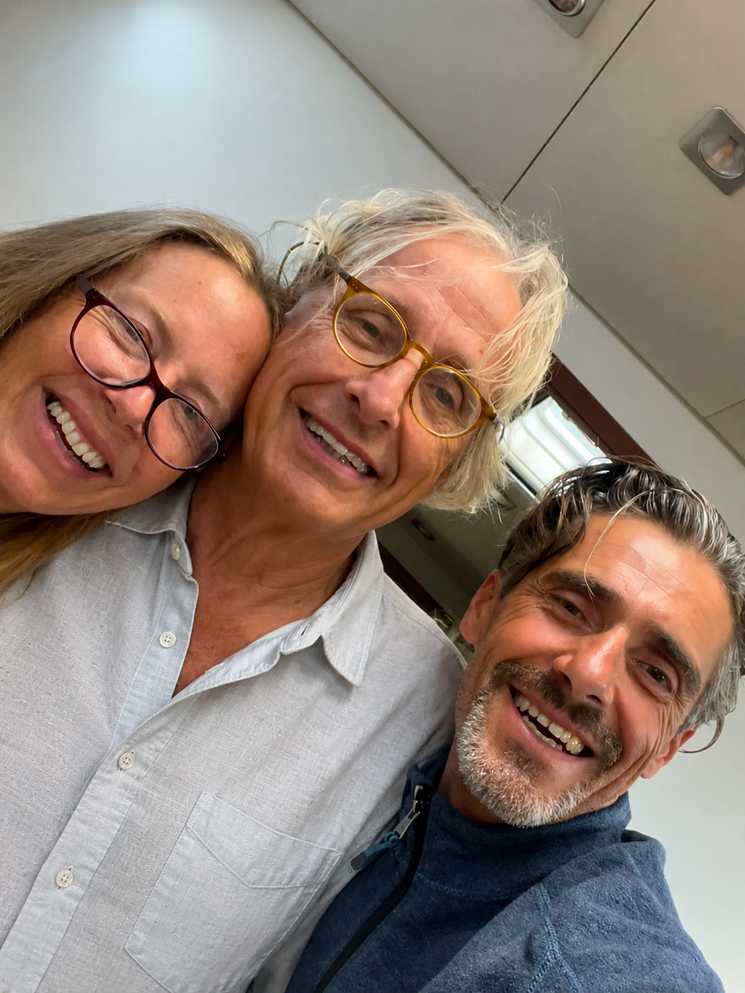 Pierre with family, smiling close together.